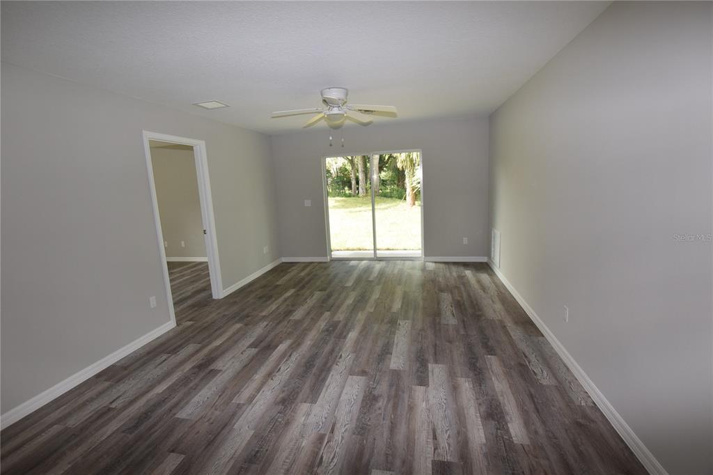 220 Danvers Street Eustis, FL 32726 - Photo 7 of 15 a view of empty room with wooden floor and fan