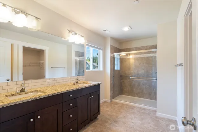 a bathroom with a granite countertop sink mirror and double