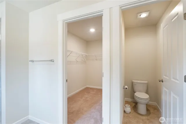 a bathroom with a toilet shower and a sink