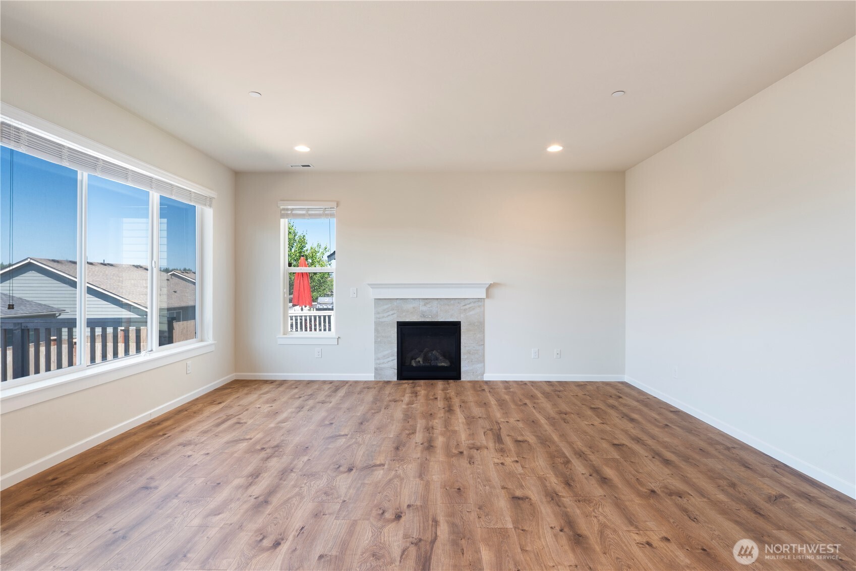 5020 51st Ave Court West University Place, WA 98467 - Photo 2 of 24 a view of an empty room with wooden floor and a window