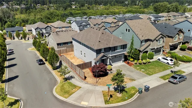 an aerial view of a house with a yard basket ball court and outdoor seating