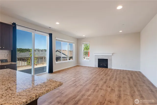 a view of livingroom with furniture fireplace and window
