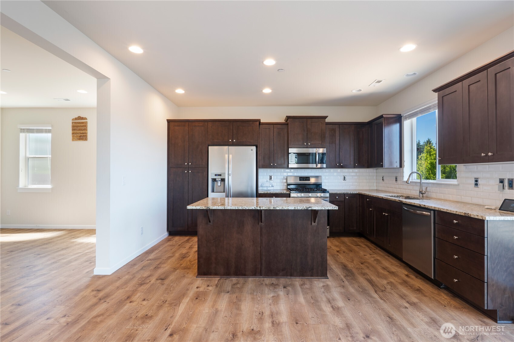 5020 51st Ave Court West University Place, WA 98467 - Photo 4 of 24 a kitchen with wooden floors and wooden cabinets