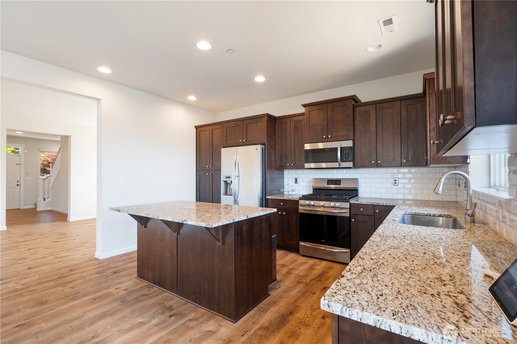 5020 51st Ave Court West University Place, WA 98467 - Photo 5 of 24 a kitchen with stainless steel appliances granite countertop a sink stove and refrigerator