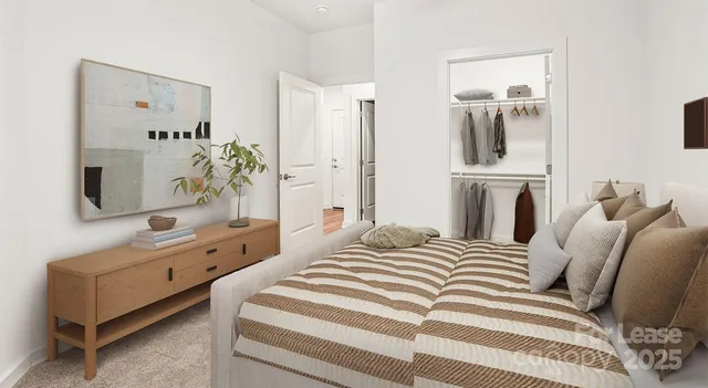 a bedroom with a bed a couch and dresser