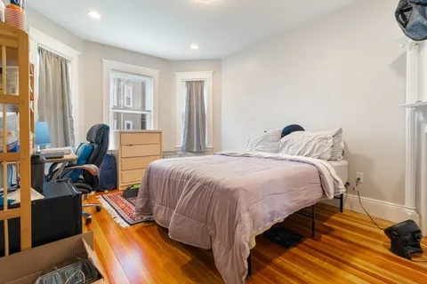 a bed room with a bed and a chair