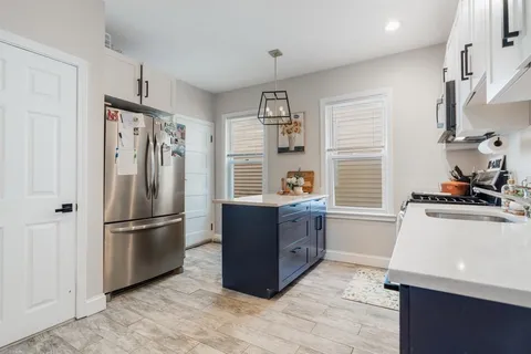 a kitchen with stainless steel appliances granite countertop a refrigerator and a stove