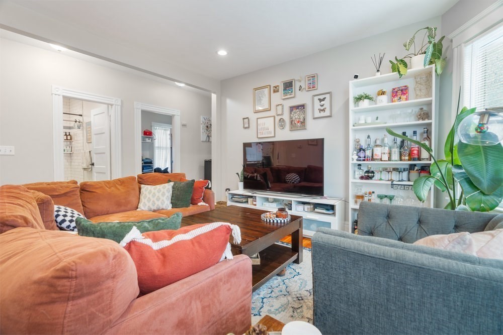 24 Buttonwood Street Boston, MA 02125 - Photo 8 of 42 a living room with furniture and a flat screen tv