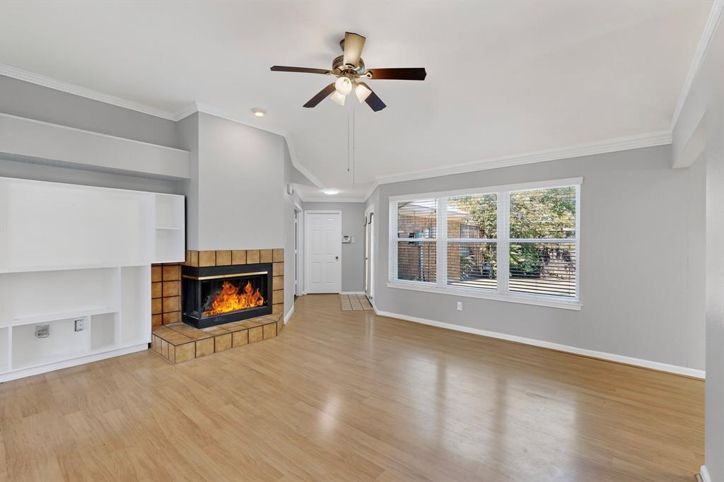 664 Phillips Drive Coppell, TX 75019 - Photo 11 of 24 a view of an empty room with a fireplace and a window