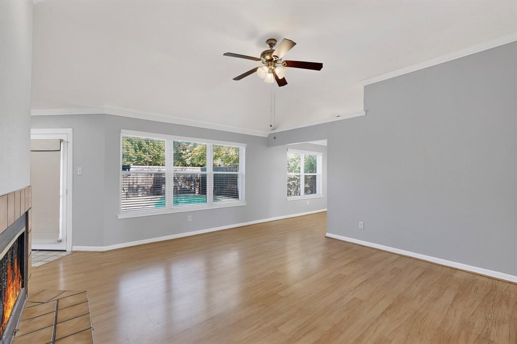 664 Phillips Drive Coppell, TX 75019 - Photo 14 of 24 an empty room with wooden floor fan and windows