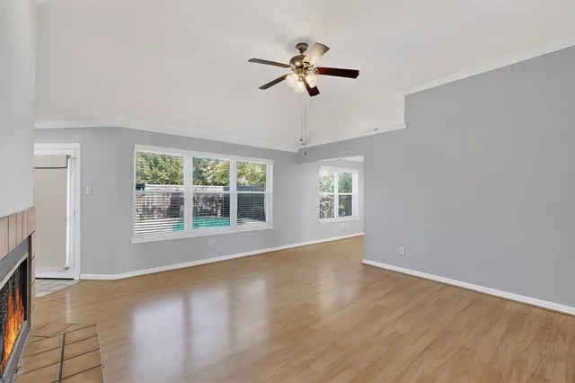 a view of an empty room with wooden floor