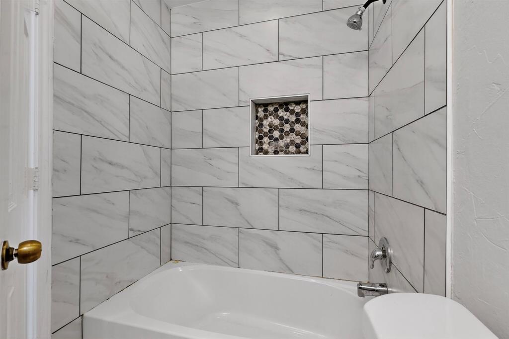 664 Phillips Drive Coppell, TX 75019 - Photo 19 of 24 a bathroom with a bathtub and shower