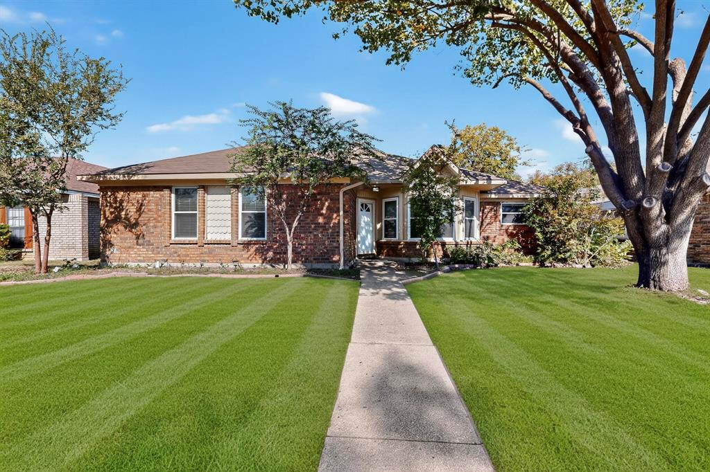 664 Phillips Drive Coppell, TX 75019 - Photo 23 of 24 a front view of a house with a yard table and chairs