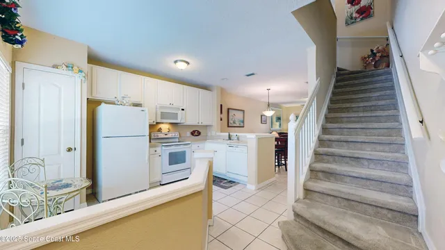 a kitchen with a sink a stove a refrigerator and cabinets