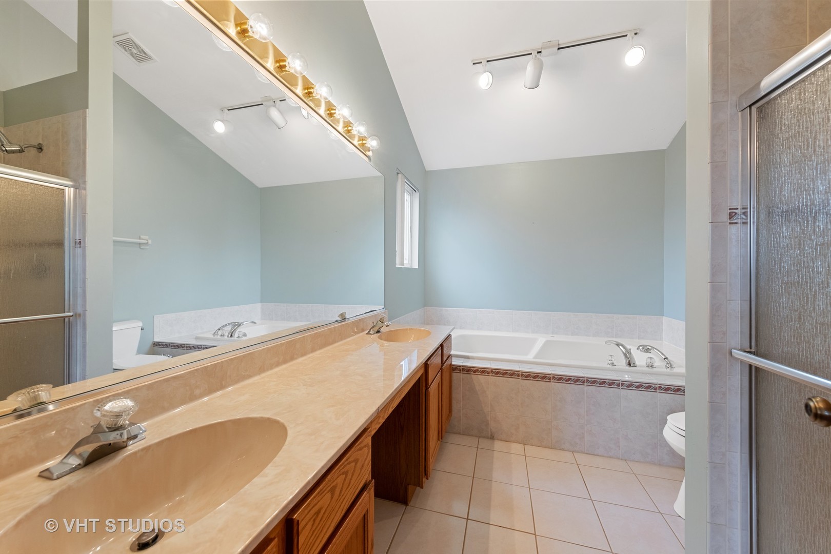 5201 Brighton Lane Plainfield, IL 60586 - Photo 14 of 18 a bathroom with a tub sink and mirror