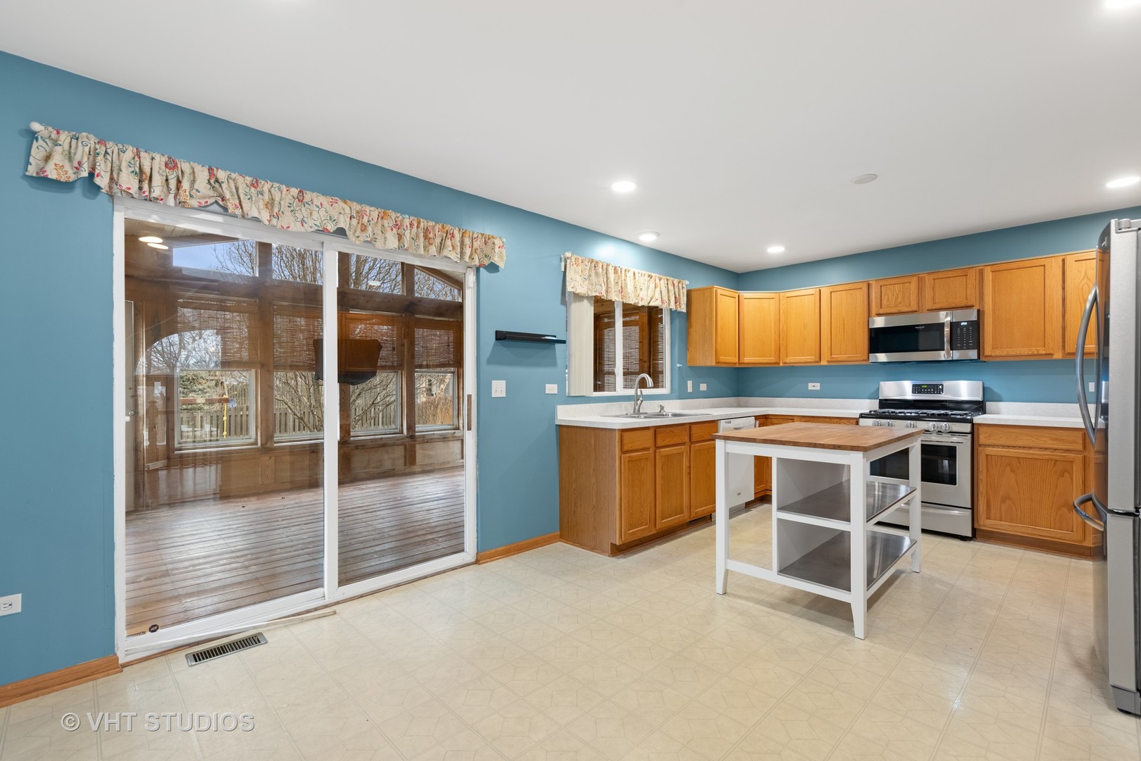 5201 Brighton Lane Plainfield, IL 60586 - Photo 6 of 18 a large kitchen with kitchen island a large window and cabinets
