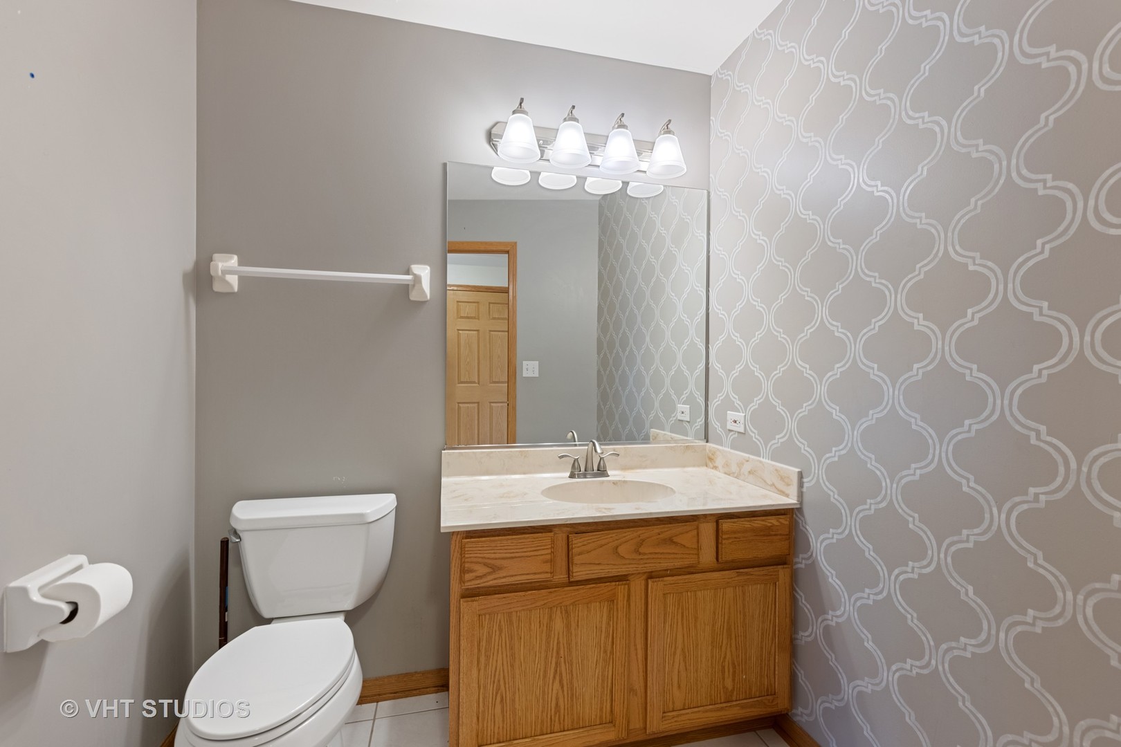 5201 Brighton Lane Plainfield, IL 60586 - Photo 8 of 18 a bathroom with a sink a toilet and mirror