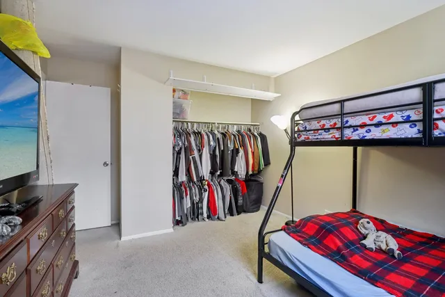 a bedroom with a bed and a walk in closet