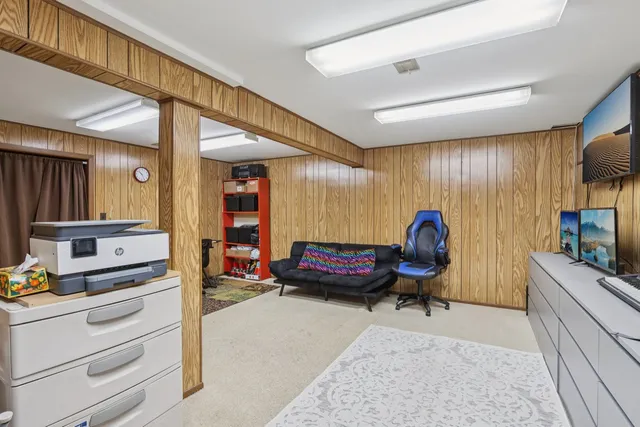 a bedroom with furniture and a flat screen tv
