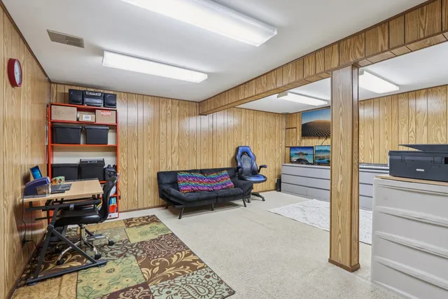 a bedroom with furniture and a book shelf