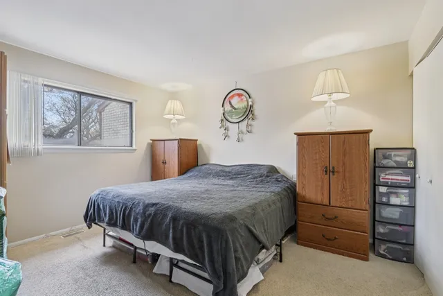 a bedroom with a bed and a dresser