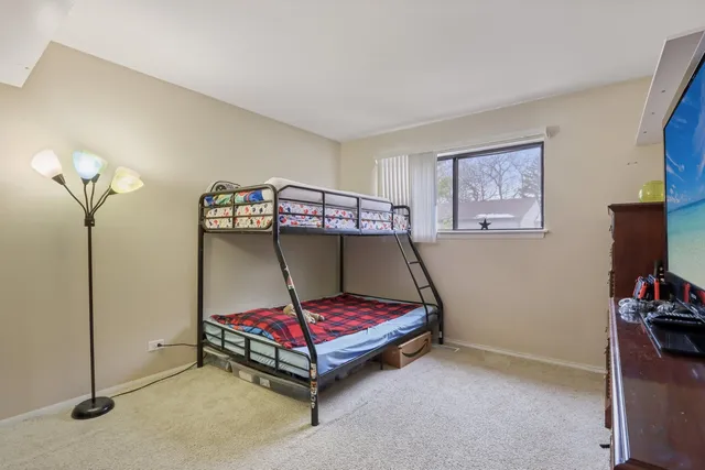 a bedroom with furniture and a flat screen tv