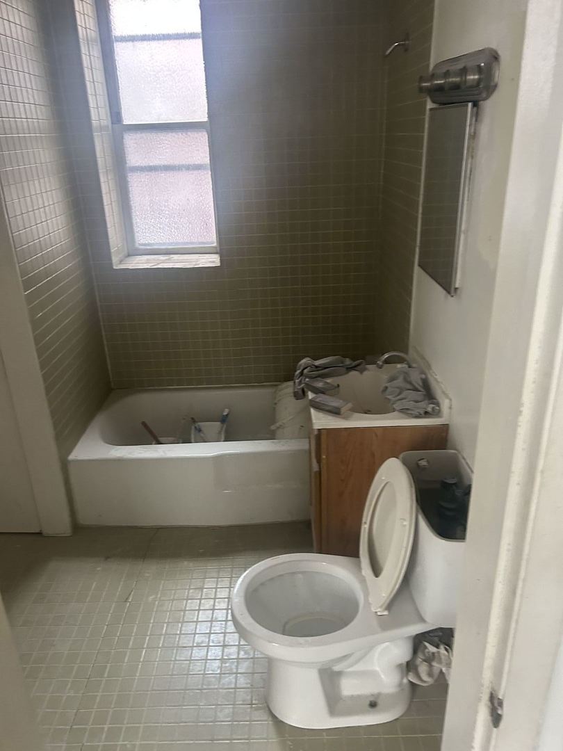1123 West Vernon Park Place Chicago, IL 60607 - Photo 11 of 27 a bathroom with a toilet and a sink