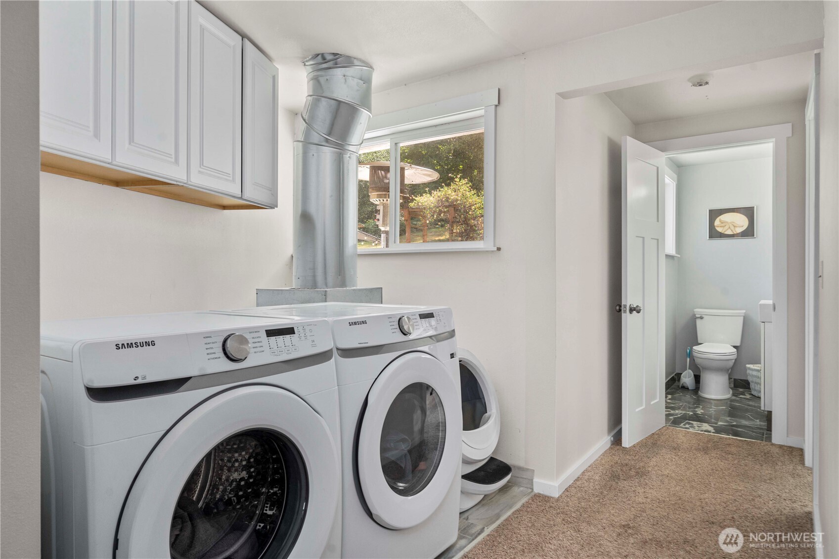 18201 Renton-Maple Valley Road Maple Valley, WA 98038 - Photo 16 of 37 a view of a hallway with washer and dryer