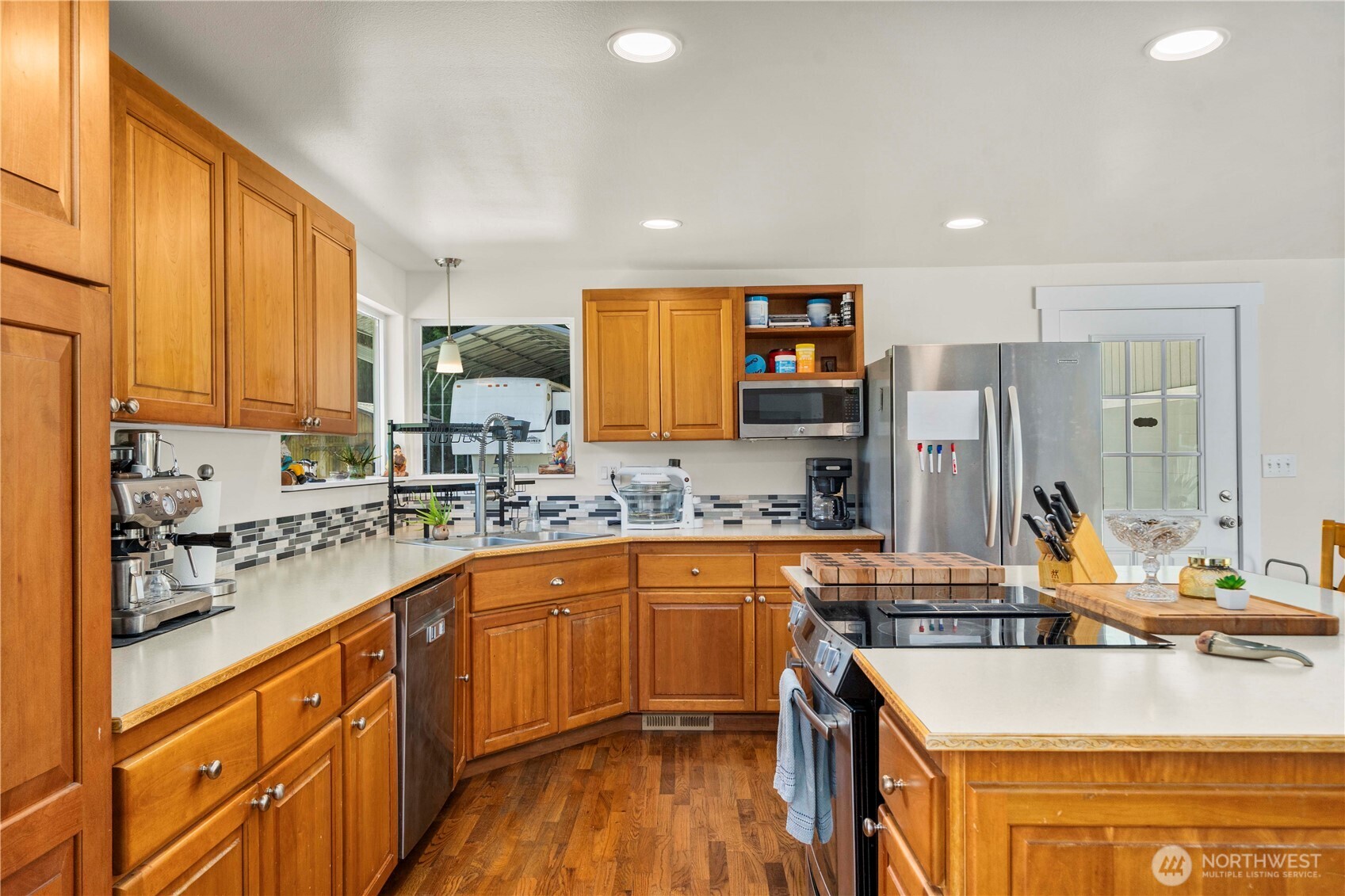 18201 Renton-Maple Valley Road Maple Valley, WA 98038 - Photo 6 of 37 a kitchen with stainless steel appliances granite countertop a sink stove and refrigerator