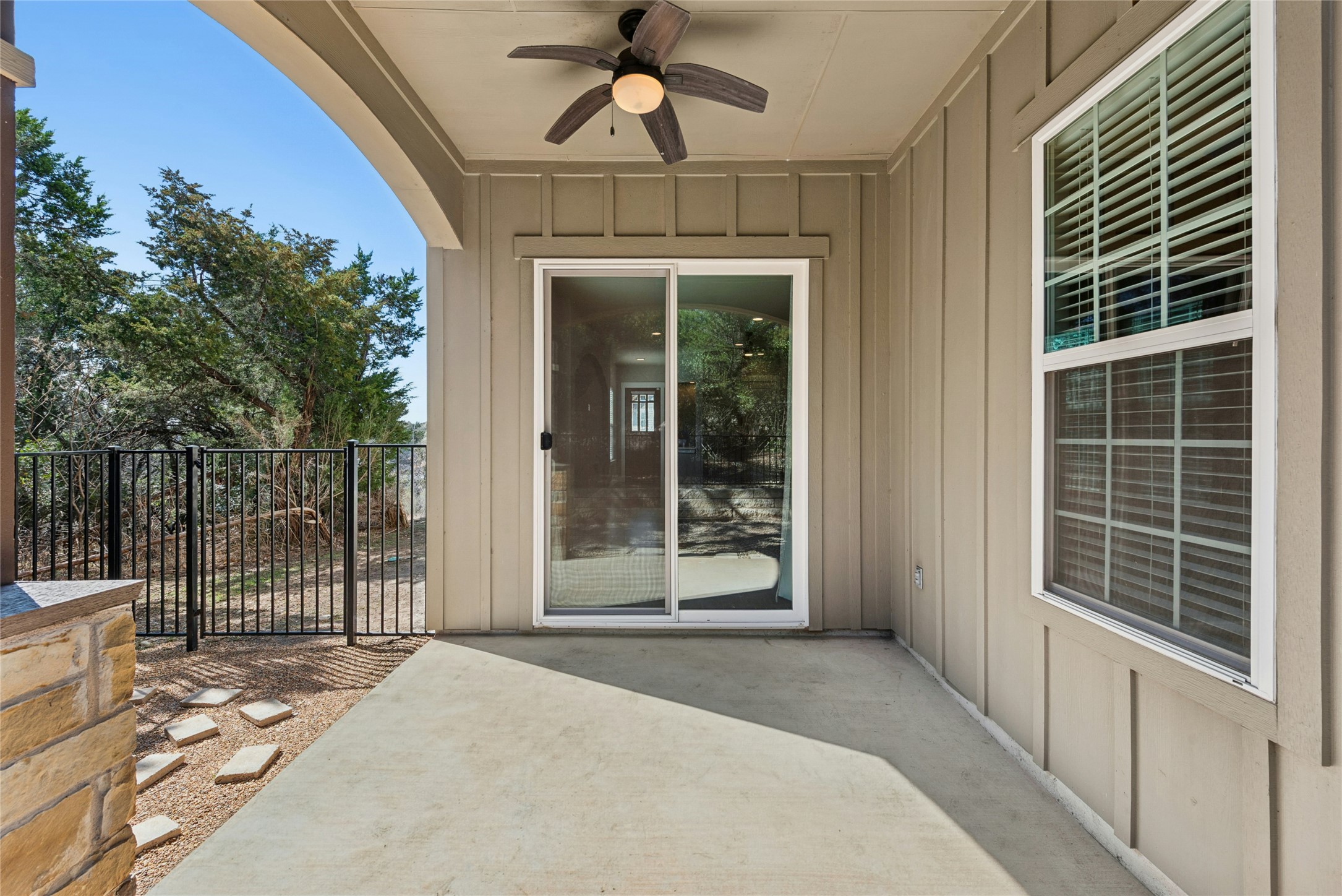 4301 Mansfield Dam Road, Unit 2101 Austin, TX 78734 - Photo 16 of 17 Property entrance featuring board and batten siding, a patio, and a ceiling fan