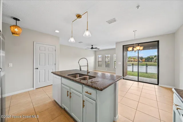 a kitchen with stainless steel appliances granite countertop a sink a counter space and cabinets