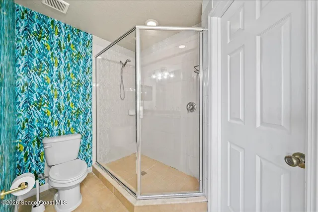 a bathroom with a toilet and shower