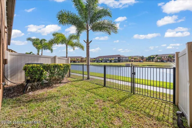 a front view of a residential apartment building with a yard