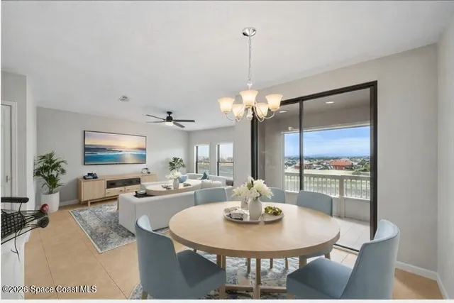 a view of a dining room with furniture a chandelier and wooden floor