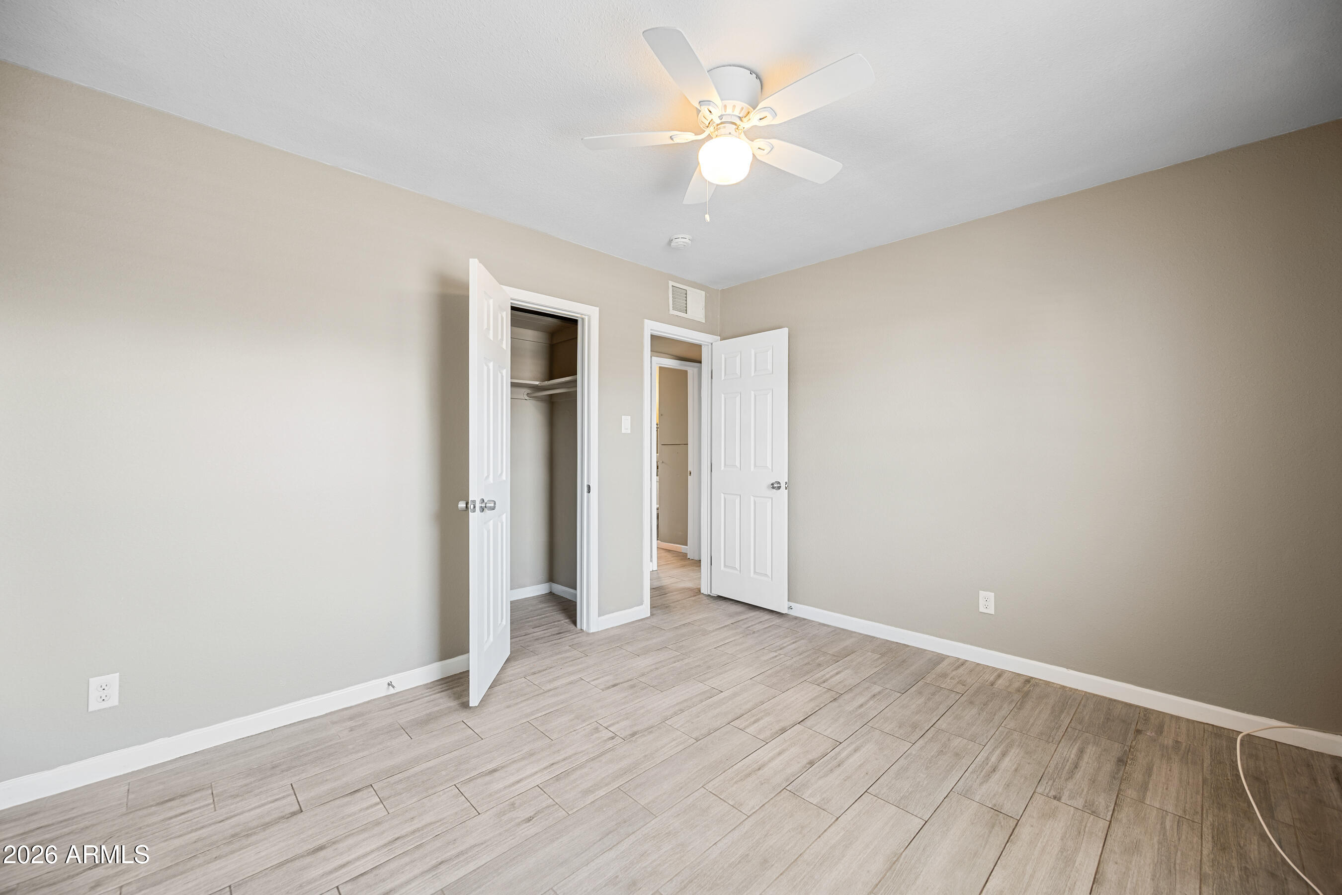 907 North 22nd Place, Unit 2 Phoenix, AZ 85006 - Photo 12 of 17 a view of an empty room with wooden floor