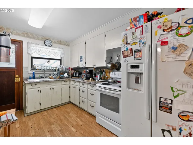 a kitchen with refrigerator and window