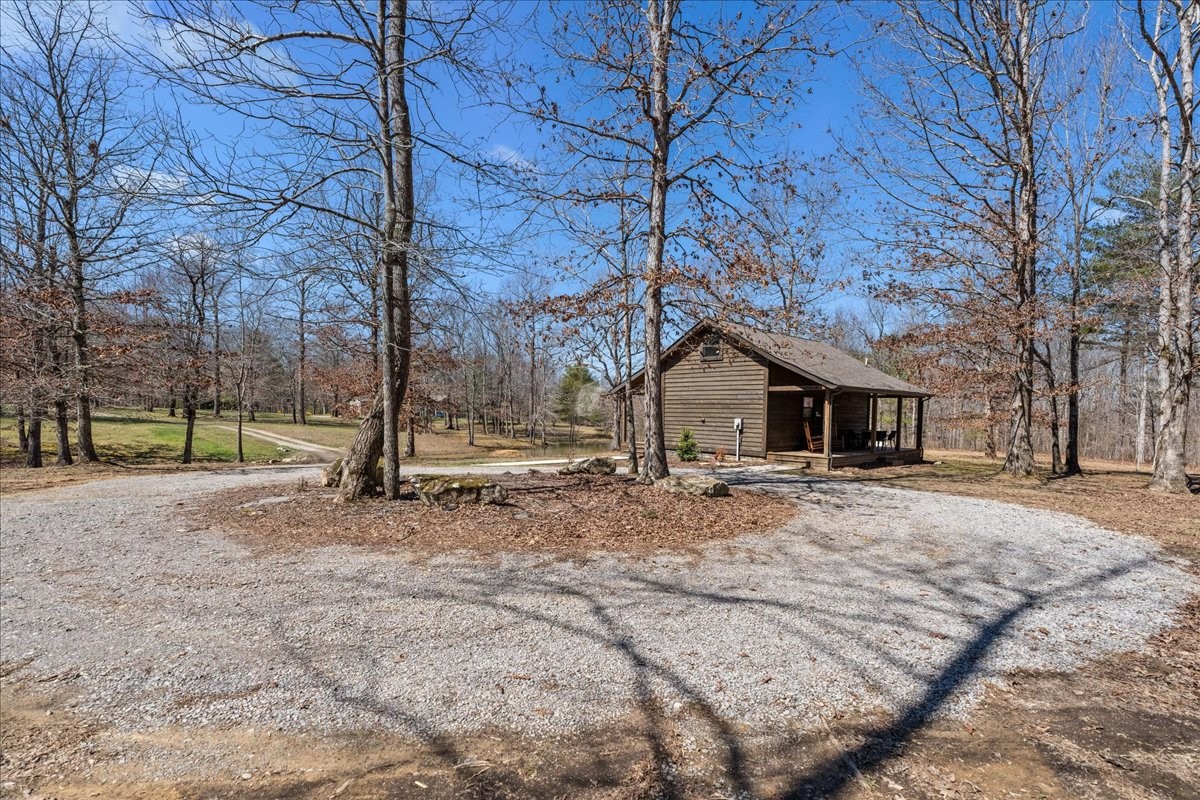 450 Flat Branch Road Tracy City, TN 37387 - Photo 25 of 57 a house with trees in front of it