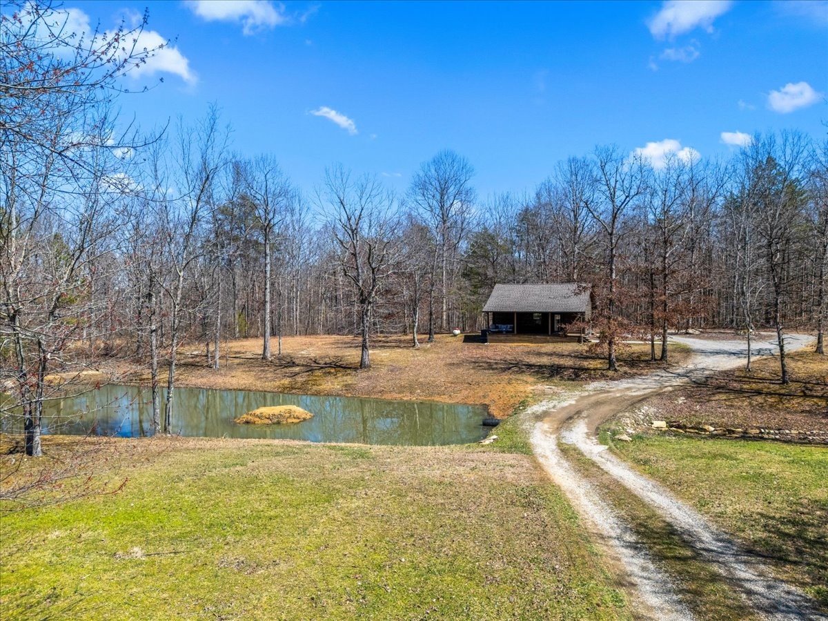 450 Flat Branch Road Tracy City, TN 37387 - Photo 3 of 57 a view of a lake with a house in the background