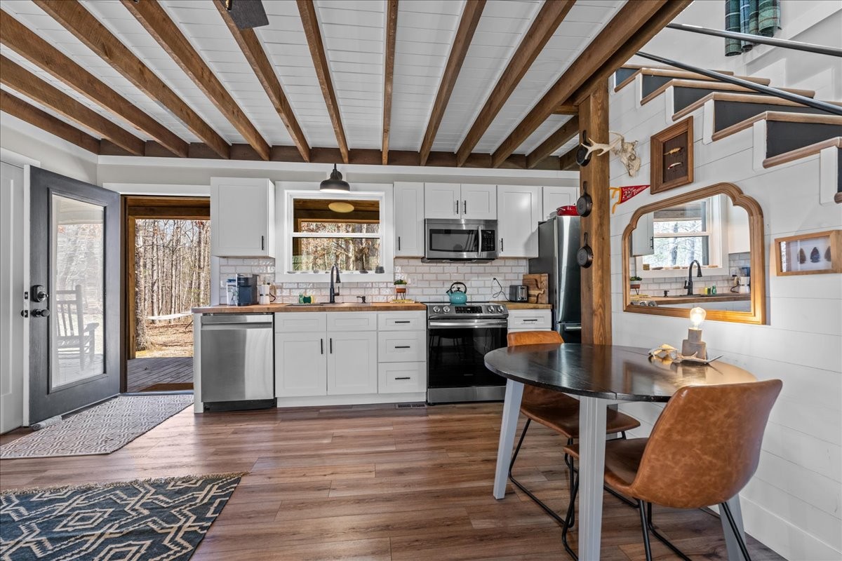 450 Flat Branch Road Tracy City, TN 37387 - Photo 31 of 57 a kitchen with stainless steel appliances kitchen island granite countertop a sink cabinets and wooden floor