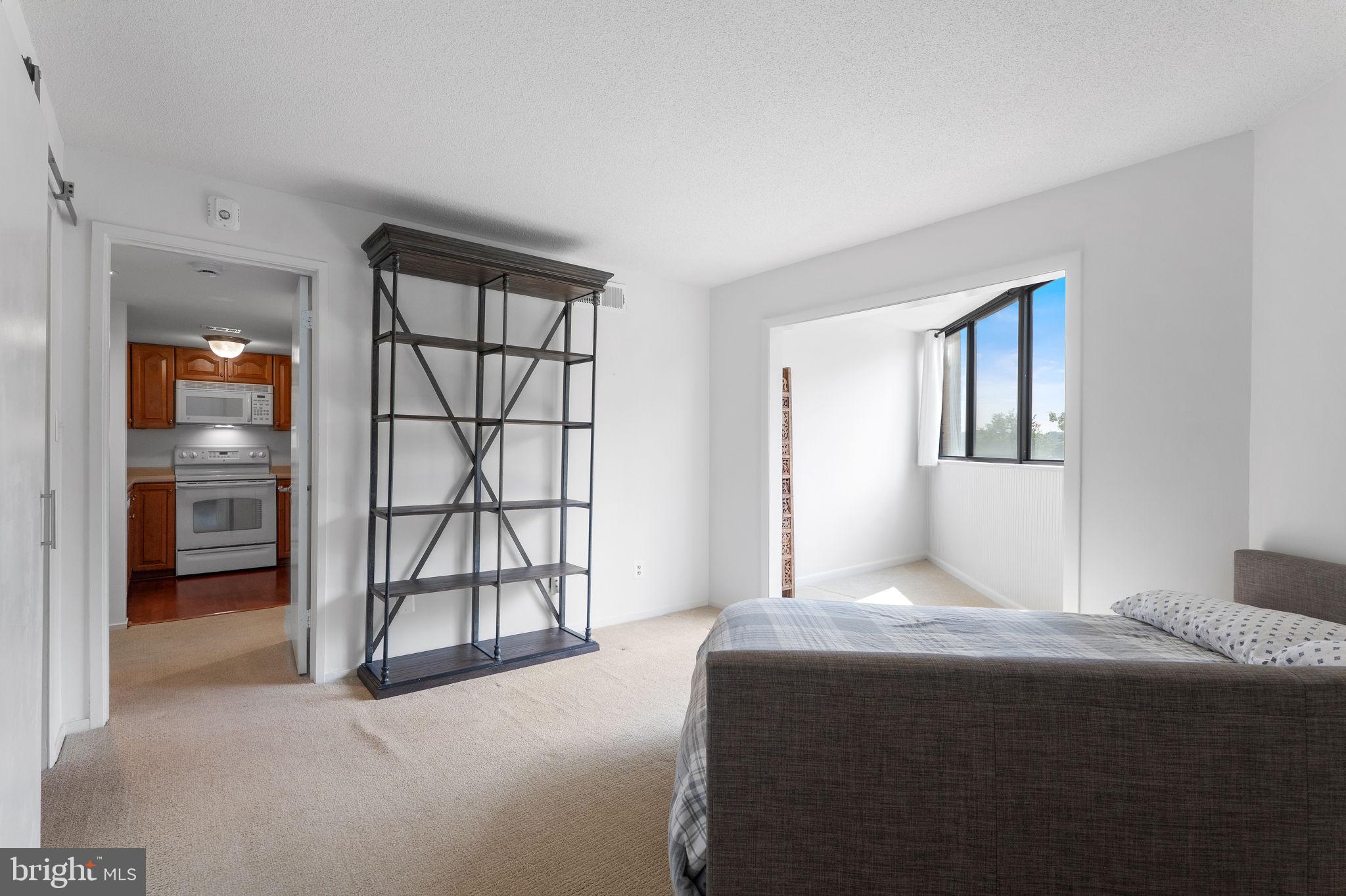 1951 Sagewood Lane, Unit 315 Reston, VA 20191 - Photo 11 of 37 a bedroom with a bed and a window