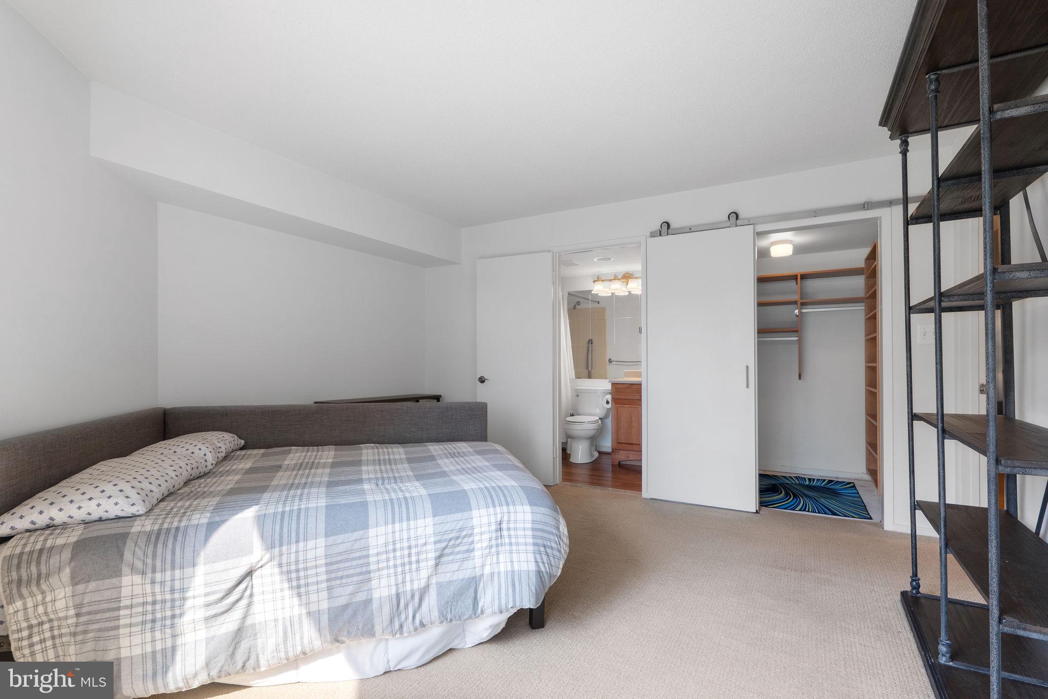 1951 Sagewood Lane, Unit 315 Reston, VA 20191 - Photo 13 of 37 a bedroom with a bed and a walk in closet
