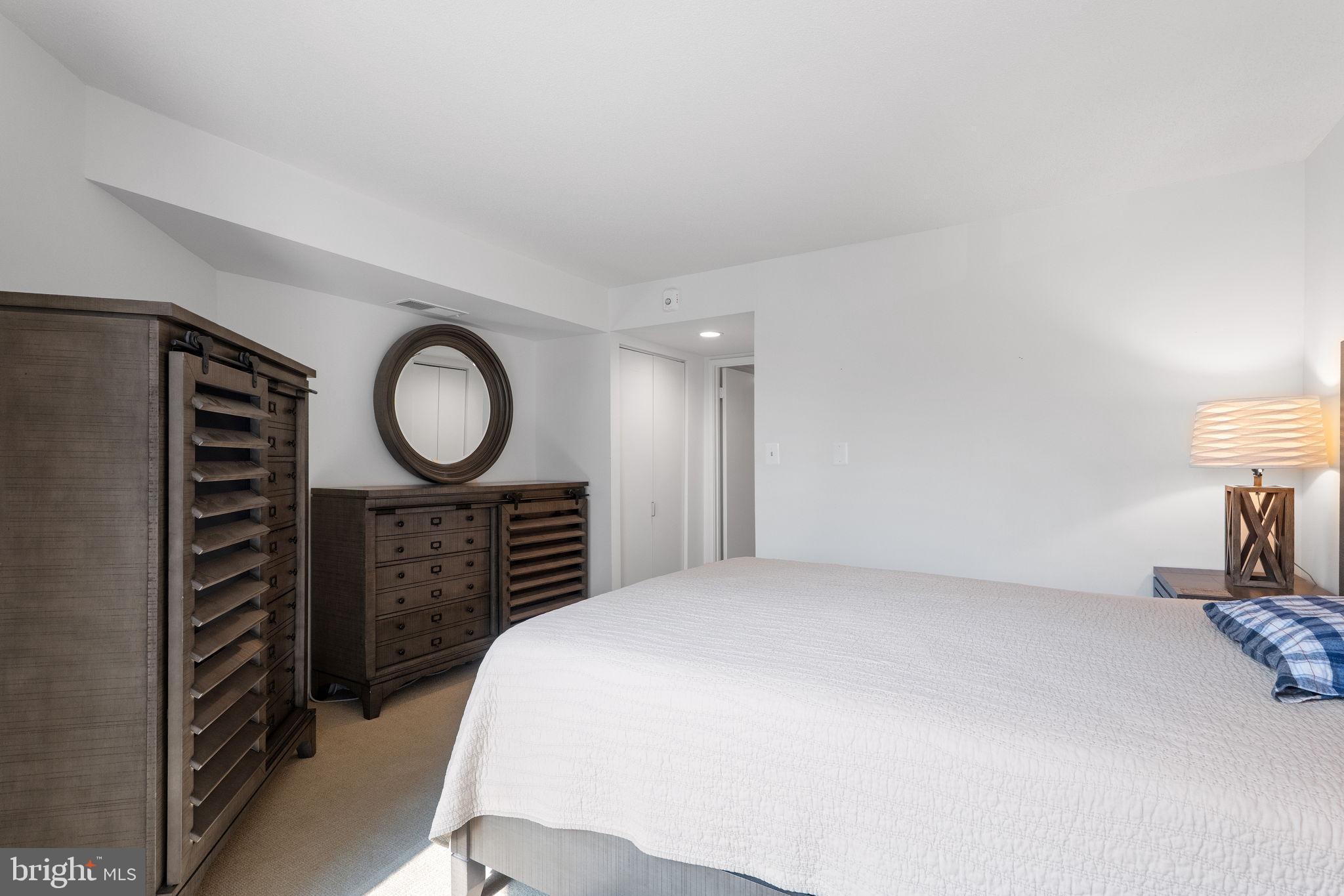 1951 Sagewood Lane, Unit 315 Reston, VA 20191 - Photo 17 of 37 a bedroom with a bed and a lamp on the dresser
