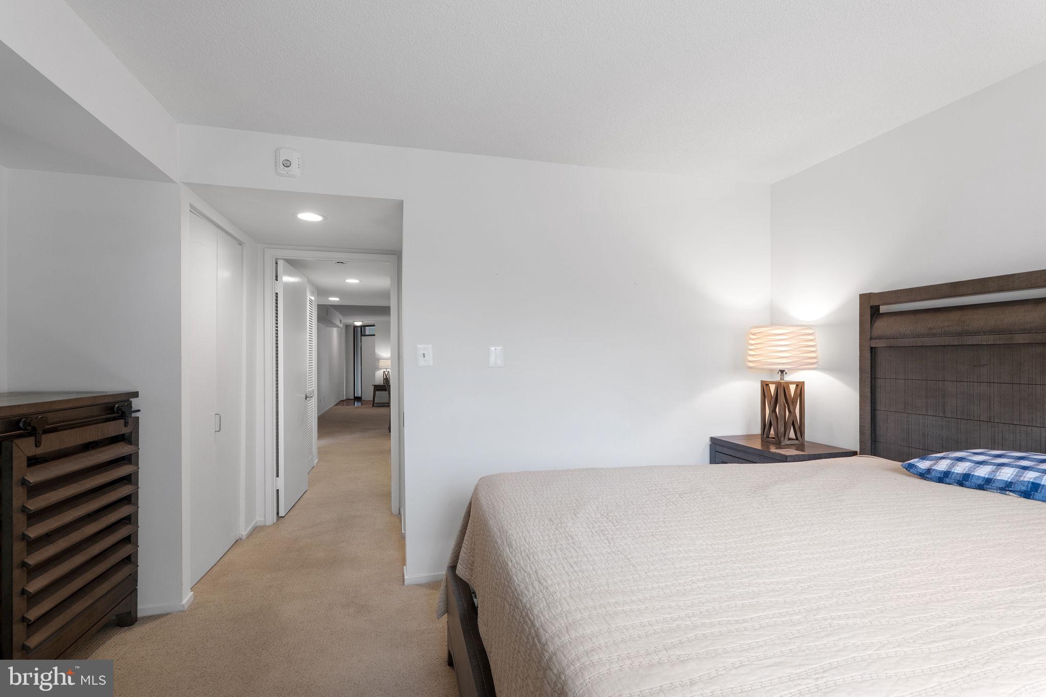 1951 Sagewood Lane, Unit 315 Reston, VA 20191 - Photo 18 of 37 a bedroom with a bed and lamp