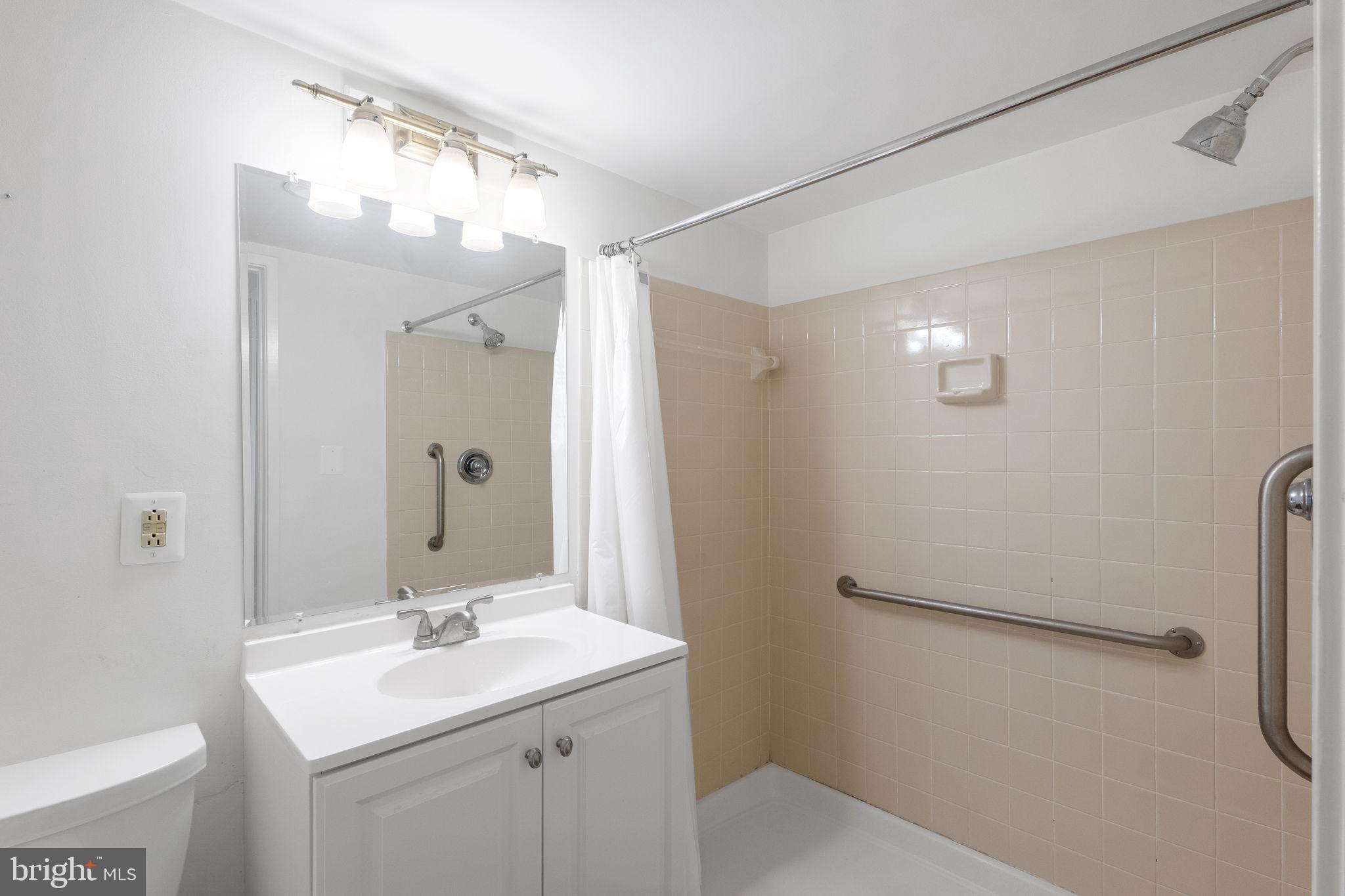 1951 Sagewood Lane, Unit 315 Reston, VA 20191 - Photo 19 of 37 a bathroom with a sink and mirror