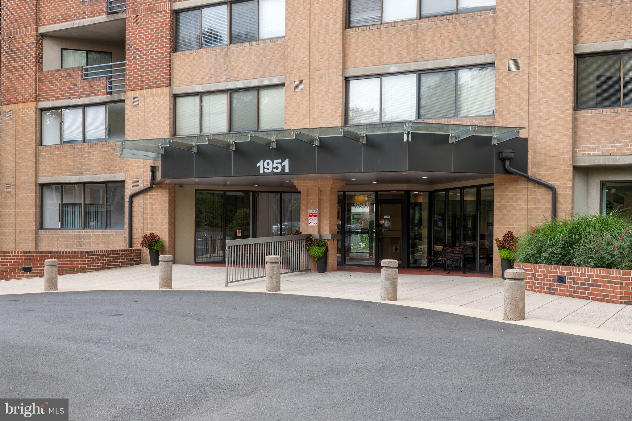 1951 Sagewood Lane, Unit 315 Reston, VA 20191 - Photo 2 of 37 a front view of a building with street
