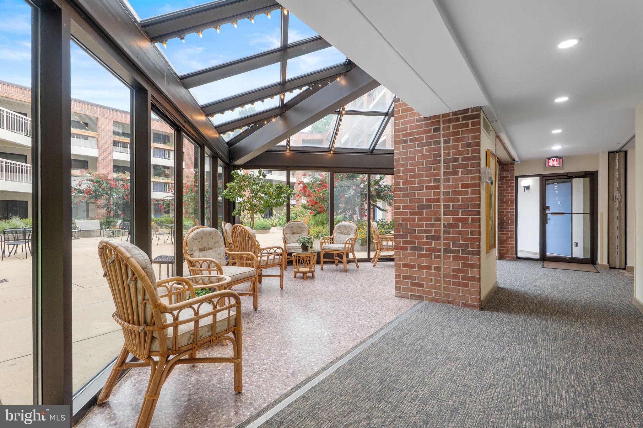 1951 Sagewood Lane, Unit 315 Reston, VA 20191 - Photo 23 of 37 a living room with furniture and a floor to ceiling window