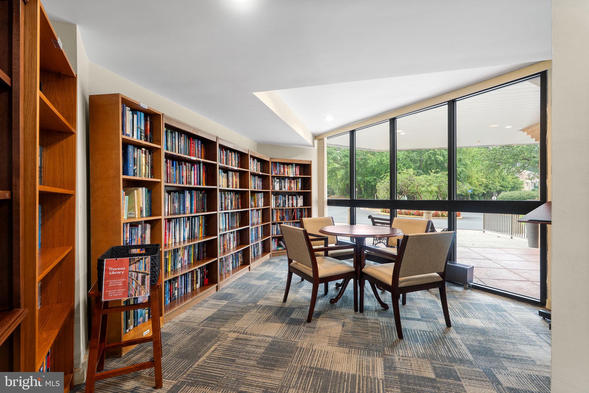 1951 Sagewood Lane, Unit 315 Reston, VA 20191 - Photo 25 of 37 a dining room with furniture and a book shelf