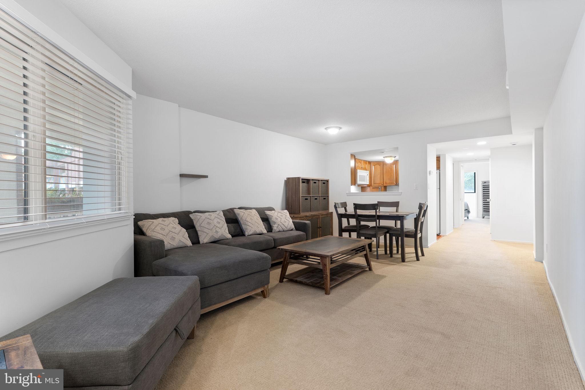 1951 Sagewood Lane, Unit 315 Reston, VA 20191 - Photo 5 of 37 a living room with furniture and a large window