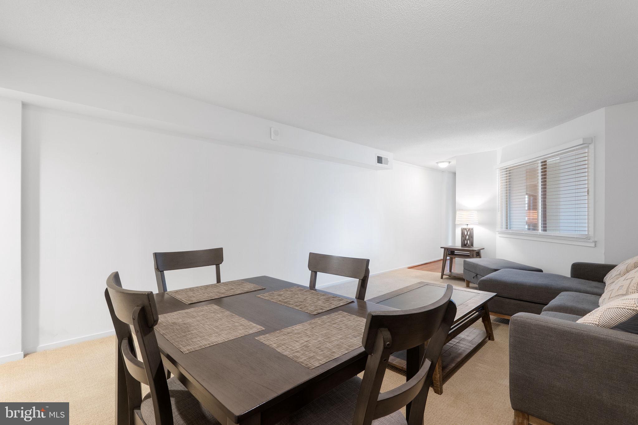 1951 Sagewood Lane, Unit 315 Reston, VA 20191 - Photo 7 of 37 a view of a dining room with furniture and wooden floor