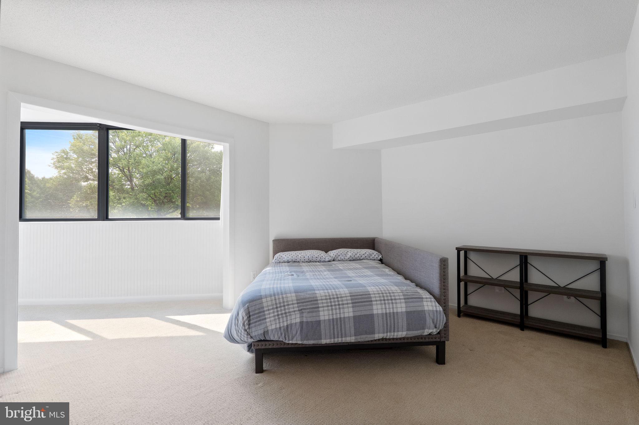 1951 Sagewood Lane, Unit 315 Reston, VA 20191 - Photo 10 of 37 a bedroom with a bed and window